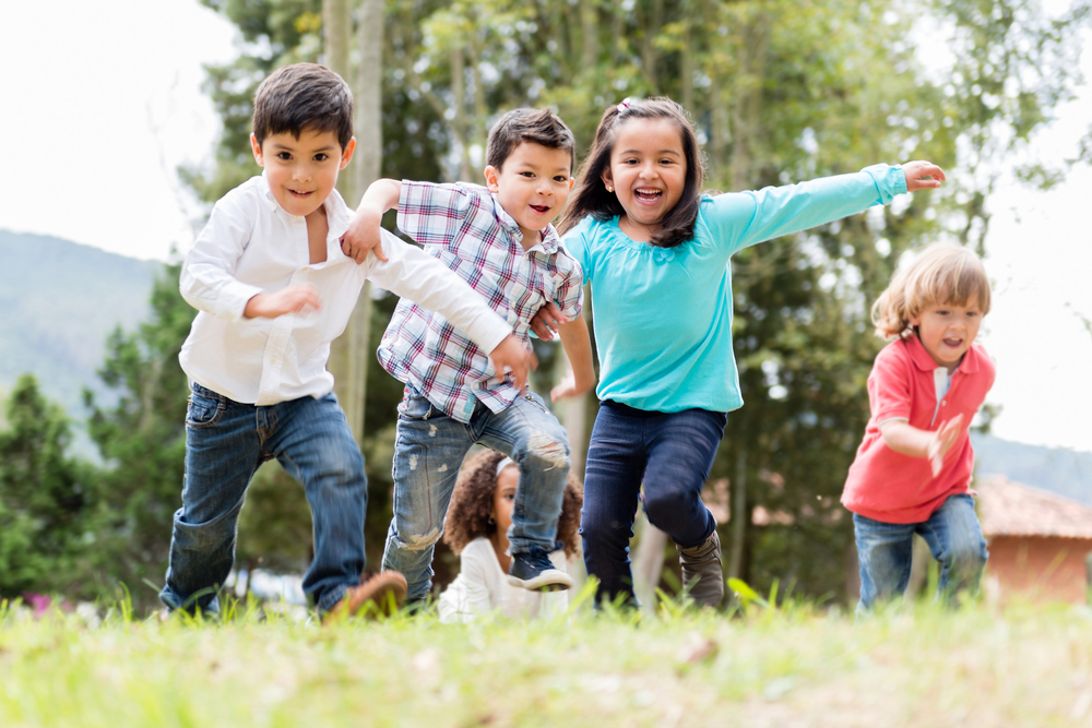 Happy group of kids playing at the park