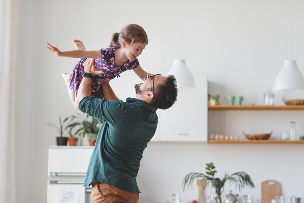Happy daughter hugs his dad on holiday