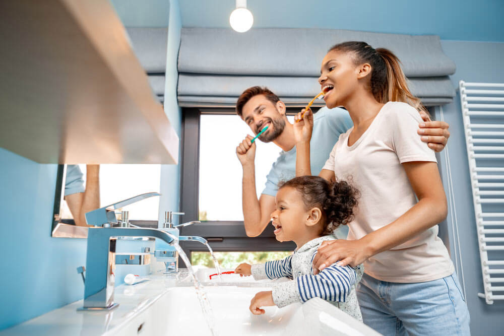 happy family brushing teeth at morning