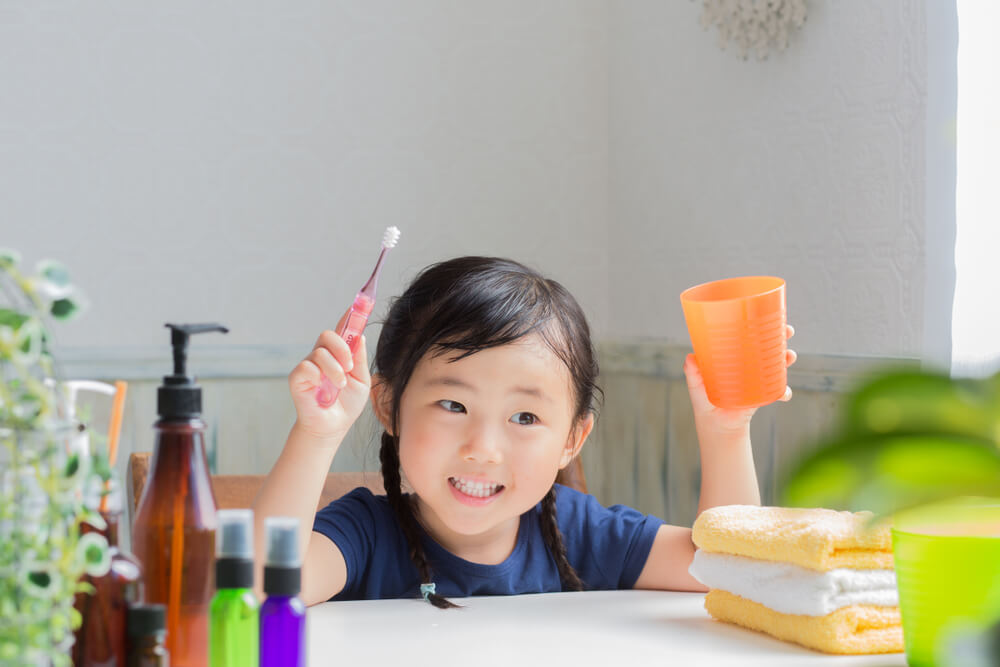 little girl brushing teeth